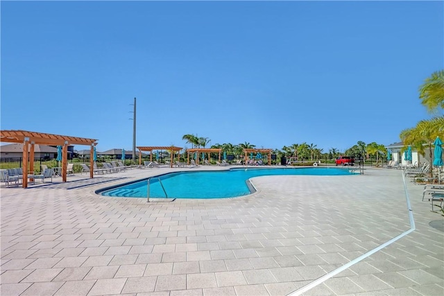 view of swimming pool with a patio area and a pergola