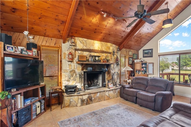 living area with wooden ceiling, a fireplace, beam ceiling, and light tile patterned flooring