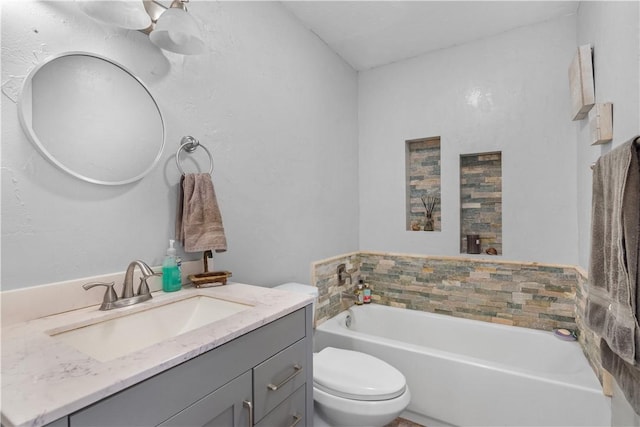 bathroom featuring toilet, a garden tub, and vanity