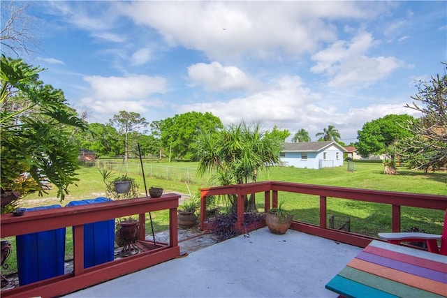 deck featuring a lawn, fence, and a patio