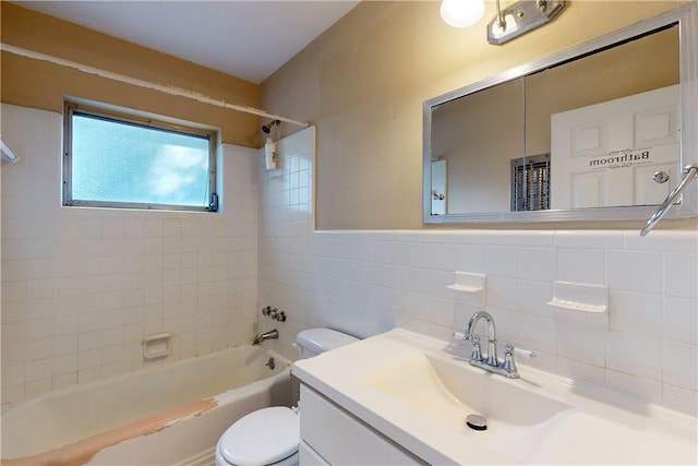 full bathroom featuring vanity, tiled shower / bath combo, tile walls, and toilet