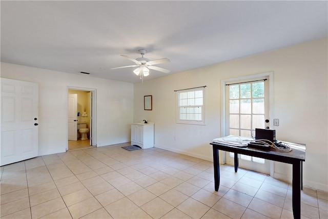 interior space with ceiling fan and light tile patterned flooring