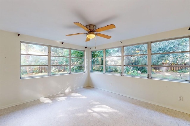 unfurnished room featuring ceiling fan, light colored carpet, and a healthy amount of sunlight