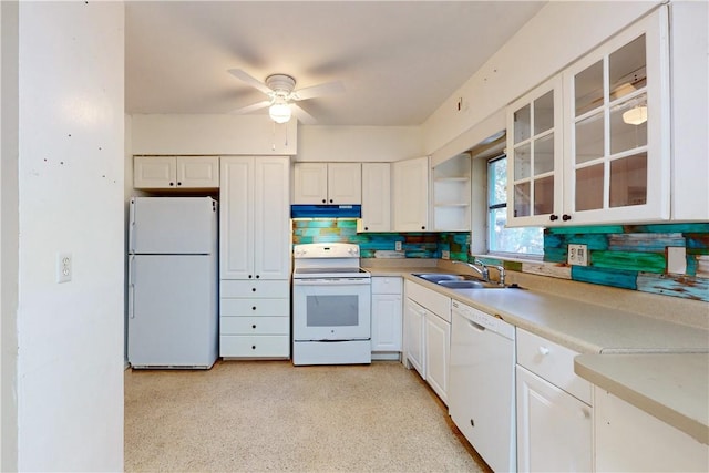 kitchen with white appliances, white cabinets, sink, decorative backsplash, and ceiling fan