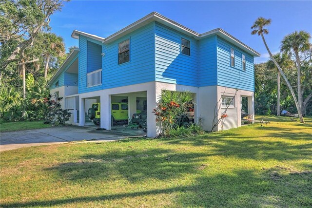 view of side of property with a lawn