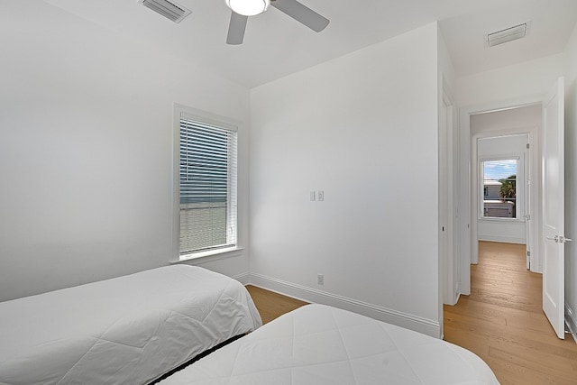 bedroom with ceiling fan and light hardwood / wood-style flooring