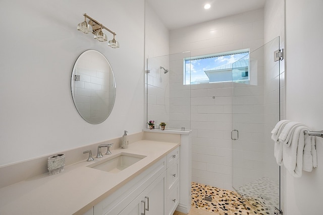 bathroom featuring vanity and a shower with shower door