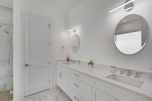 bathroom featuring a shower with shower door and vanity