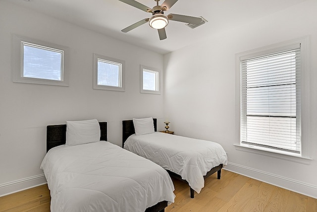 bedroom with light wood-type flooring and ceiling fan