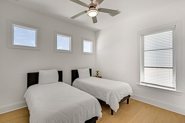 bedroom with light wood-type flooring and ceiling fan