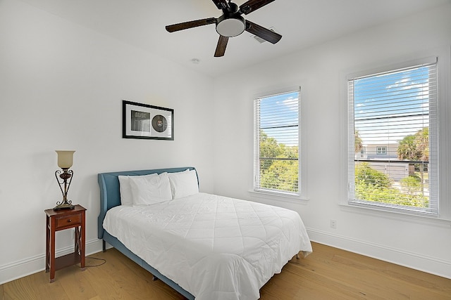 bedroom with wood-type flooring and ceiling fan