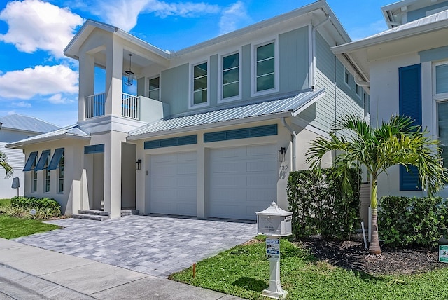 view of front of property with a garage and a balcony