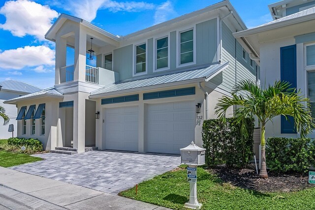 view of front of property with a garage and a balcony