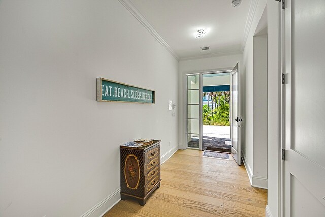 doorway to outside featuring light wood-type flooring and crown molding