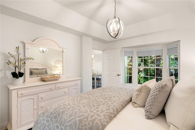 bedroom with a notable chandelier