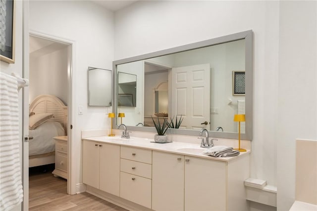 bathroom with vanity and hardwood / wood-style flooring