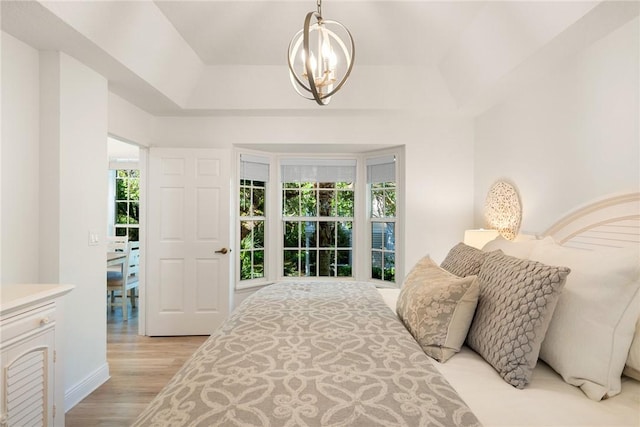 bedroom featuring light hardwood / wood-style flooring and an inviting chandelier