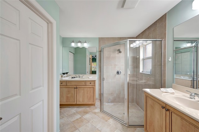 bathroom with vanity, an enclosed shower, tile patterned floors, and plenty of natural light