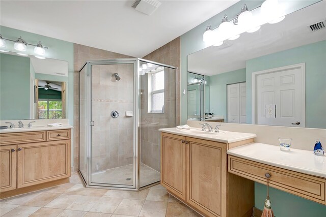 bathroom featuring ceiling fan, a shower with shower door, tile patterned flooring, and vanity