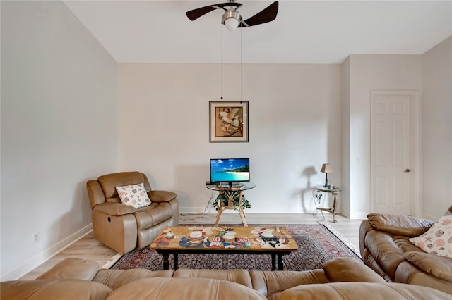 living room with light hardwood / wood-style floors and ceiling fan