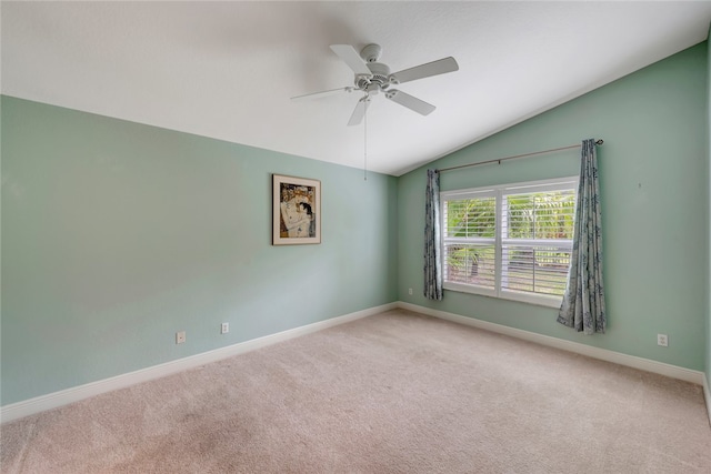 carpeted spare room with lofted ceiling and ceiling fan