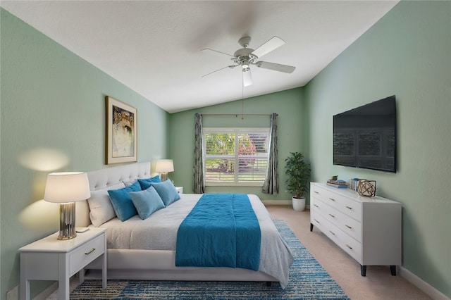 carpeted bedroom with vaulted ceiling and ceiling fan