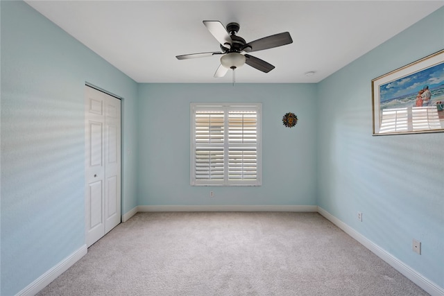 carpeted empty room featuring a wealth of natural light and ceiling fan