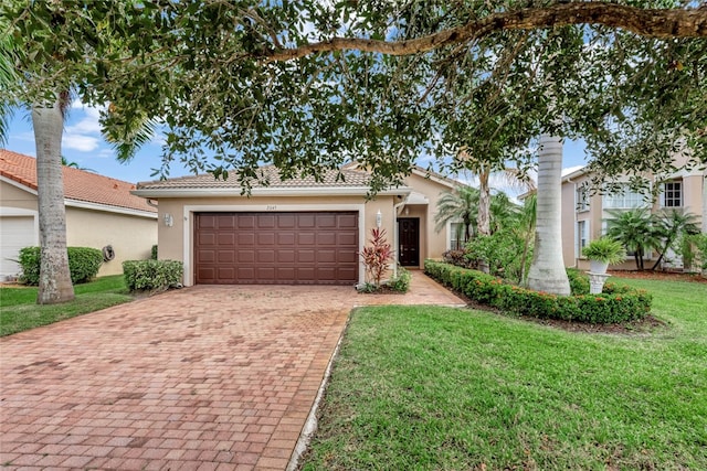 ranch-style house with a garage and a front yard