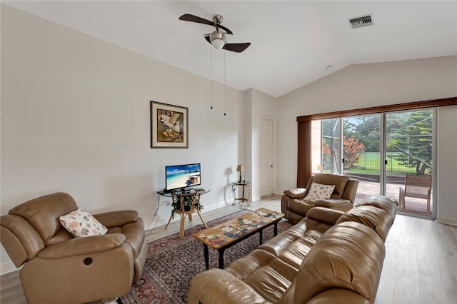 living room featuring ceiling fan, light hardwood / wood-style flooring, and lofted ceiling