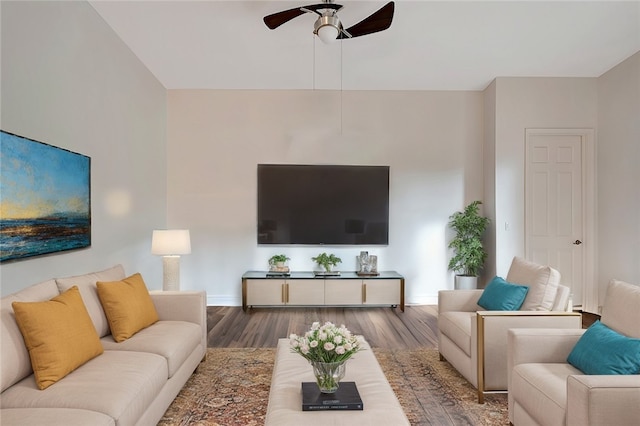 living room featuring hardwood / wood-style floors and ceiling fan