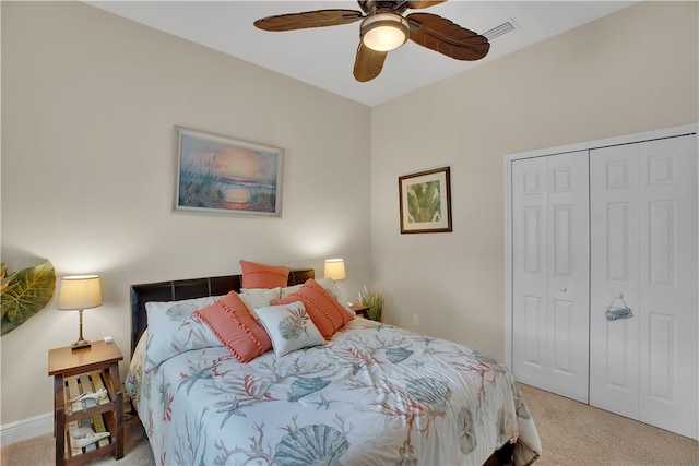 bedroom with a closet, light carpet, and ceiling fan