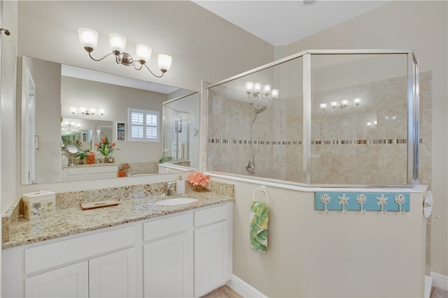 bathroom with vanity and tiled shower