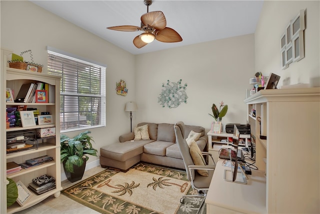 office area with light tile patterned floors and ceiling fan