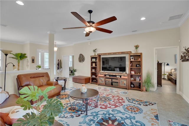 living room featuring ornate columns, light tile patterned floors, ceiling fan, and crown molding