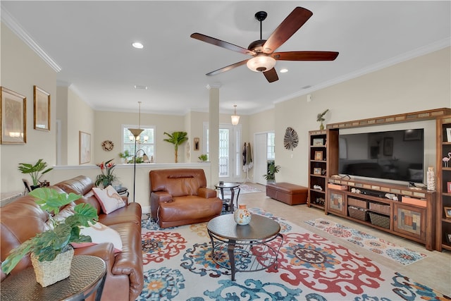 living room featuring ornamental molding, ceiling fan, and ornate columns