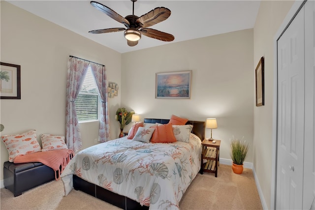 carpeted bedroom featuring a closet and ceiling fan