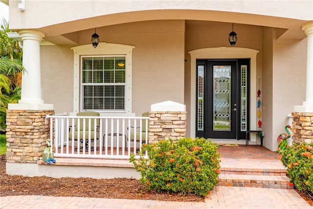 entrance to property featuring covered porch