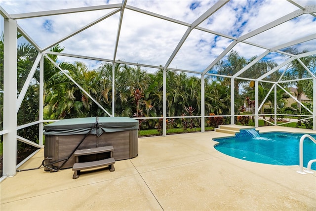 view of swimming pool with a hot tub, a patio, and glass enclosure