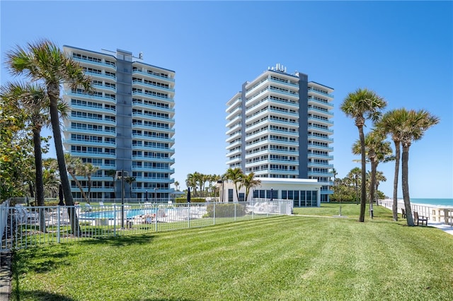 view of property with a community pool and a water view