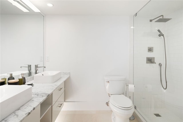 bathroom with toilet, a tile shower, and vanity