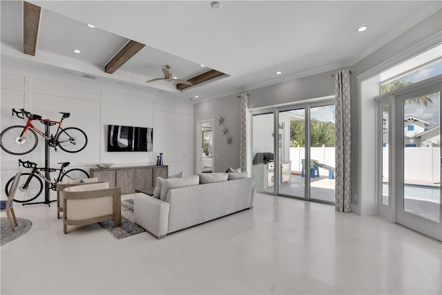 living room featuring ornamental molding, beam ceiling, ceiling fan, and plenty of natural light