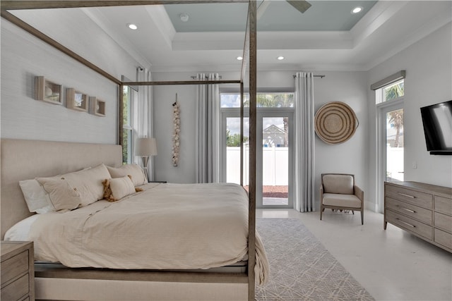 bedroom with access to exterior, a raised ceiling, and crown molding