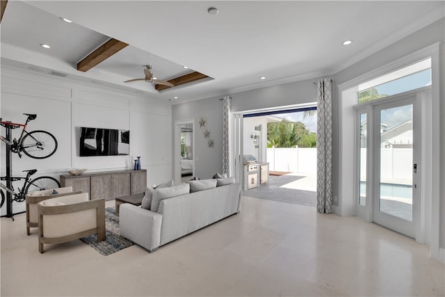 living room featuring ceiling fan, beam ceiling, and crown molding