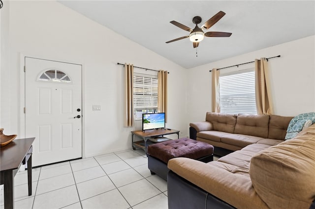 living room with ceiling fan, light tile patterned flooring, and vaulted ceiling