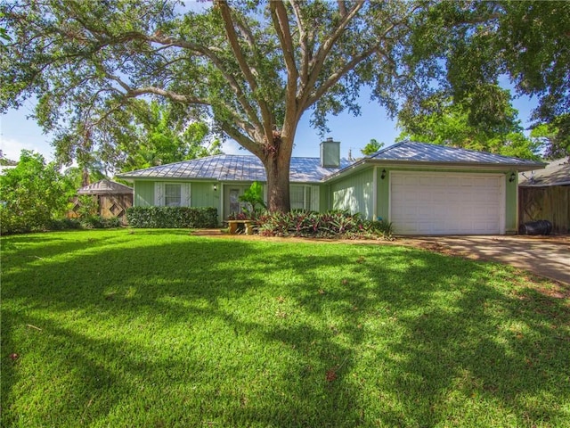 ranch-style house featuring a garage and a front lawn