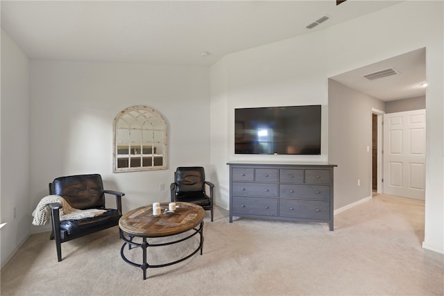 sitting room featuring light colored carpet