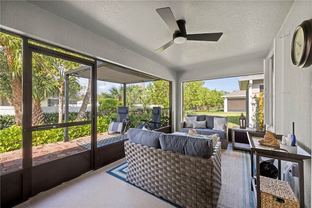 sunroom featuring ceiling fan