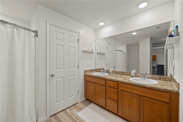 bathroom with hardwood / wood-style floors, vanity, a textured ceiling, and a shower with curtain