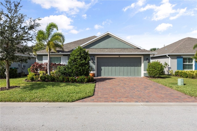 ranch-style home featuring a garage and a front lawn