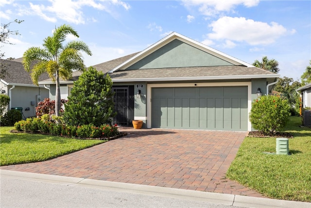 ranch-style house featuring a front lawn, a garage, and central AC